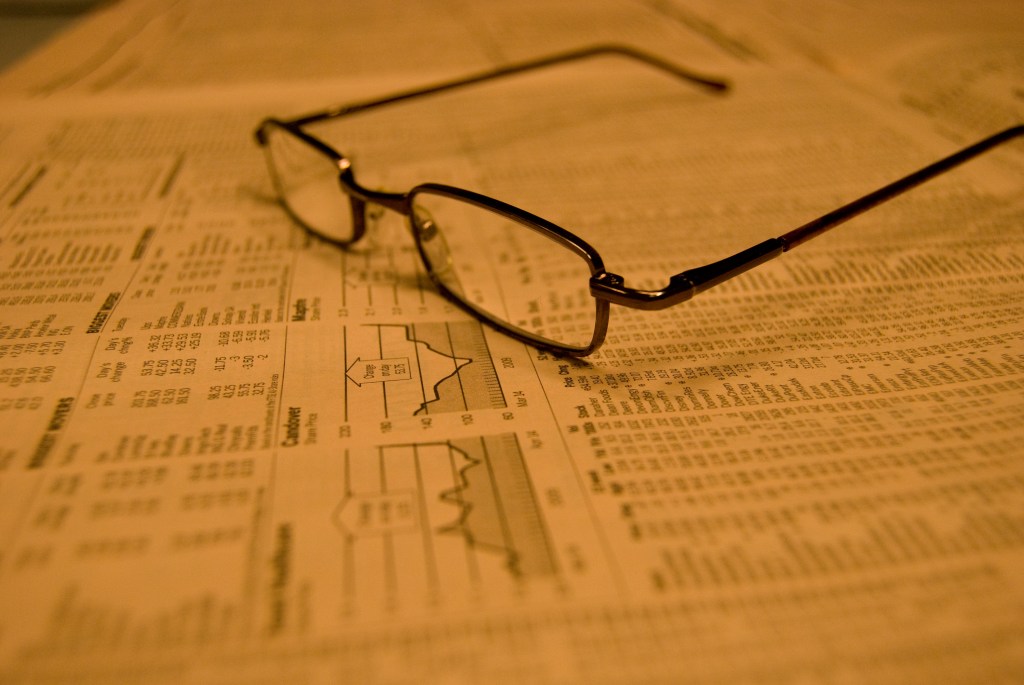 Eye glasses on stock quote page in newspaper.