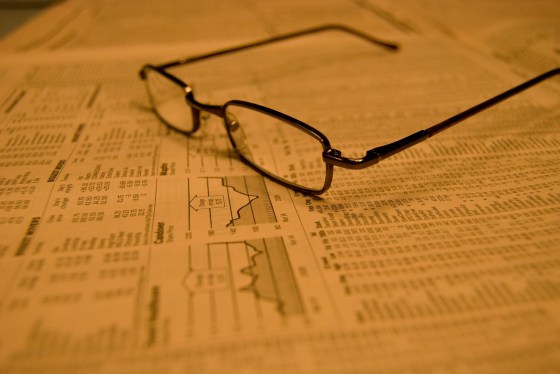 Eye glasses on stock quote page in newspaper.
