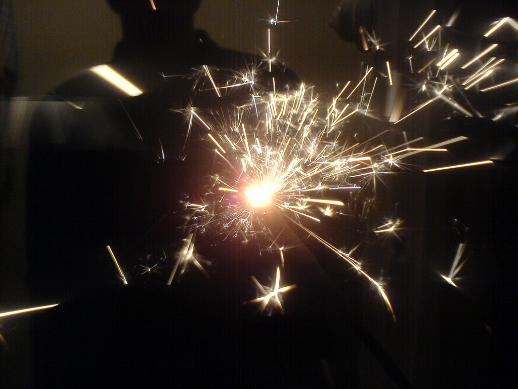 Sparks flying from a sparkler.