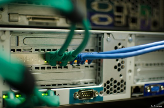 Server with green blue wires coming from it.