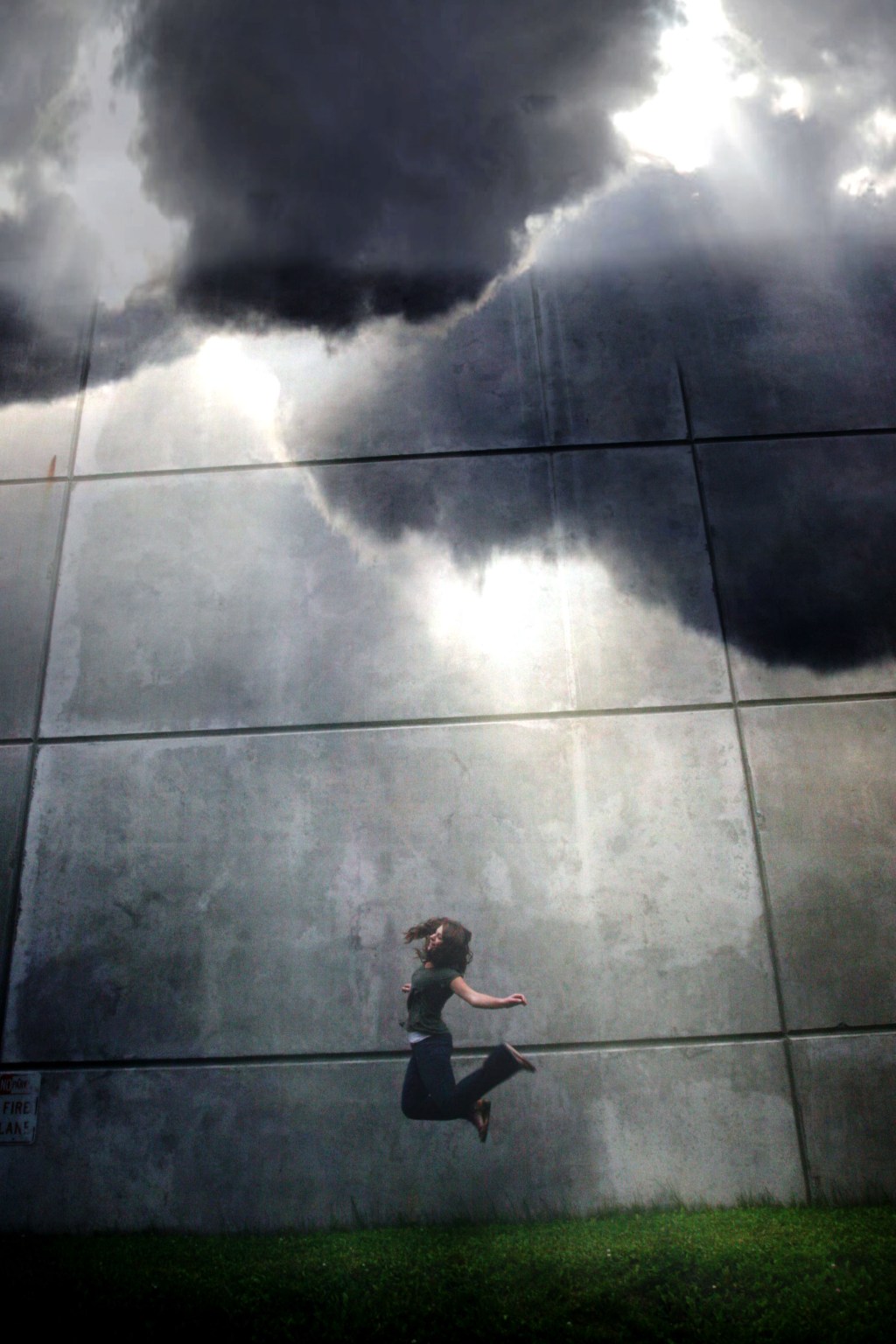 Clouds coming together and girl jumping on platform.