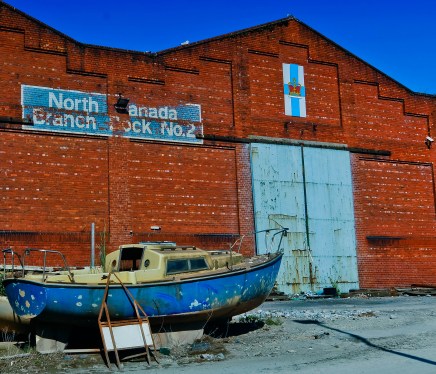 Old ship in front of a dock sign.
