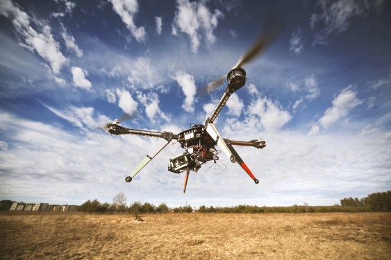 Drone flying against blue sky.
