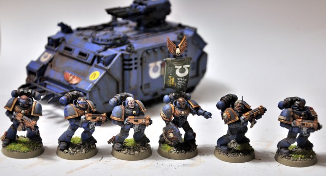 Toy soldiers in front of a toy tank.