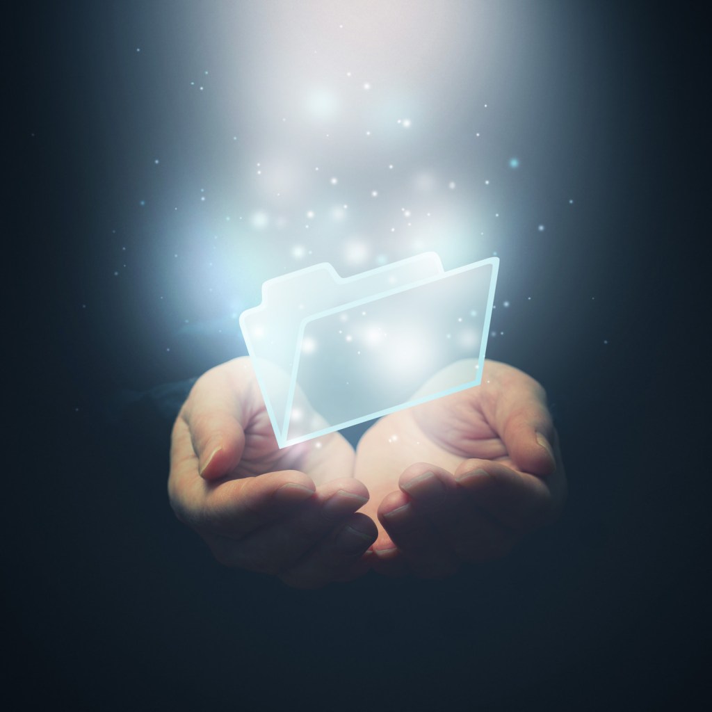 Concept photo of folder sitting inside two open hands.