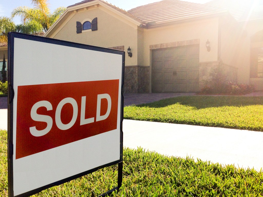 Sold sign in front of a house.