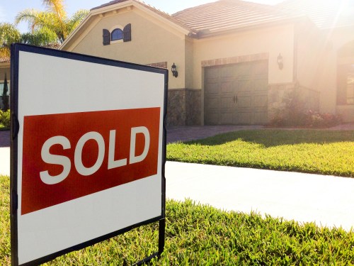 Sold sign in front of a house.