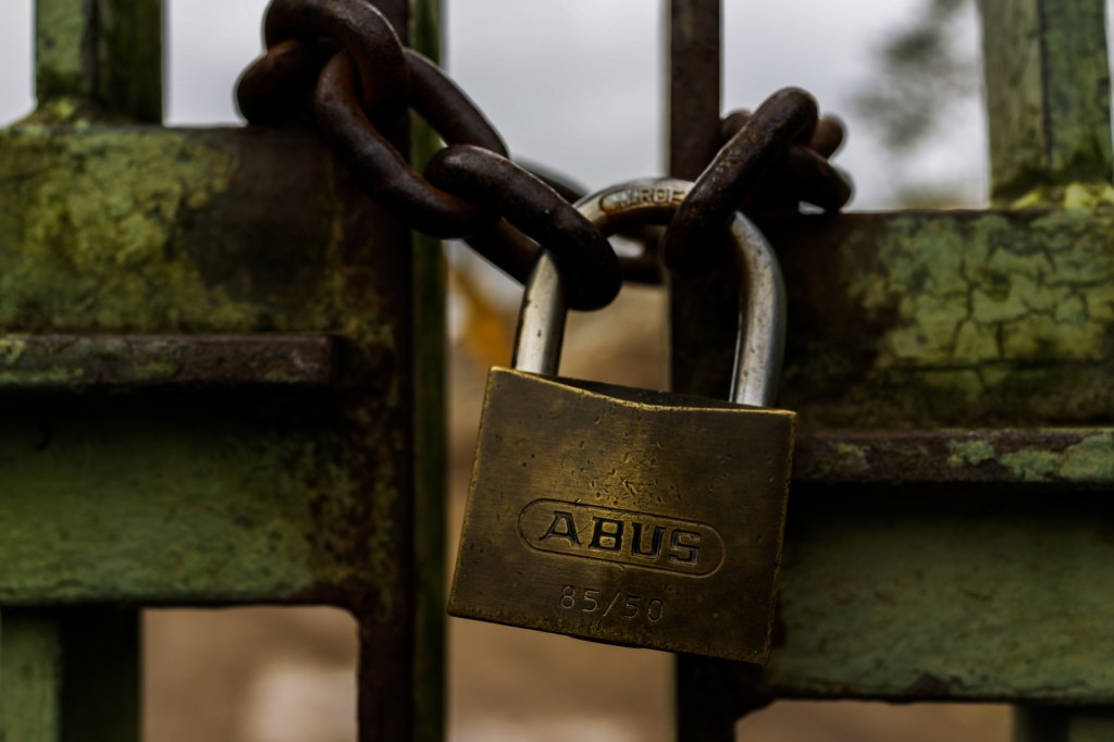 Padlocked iron gates.