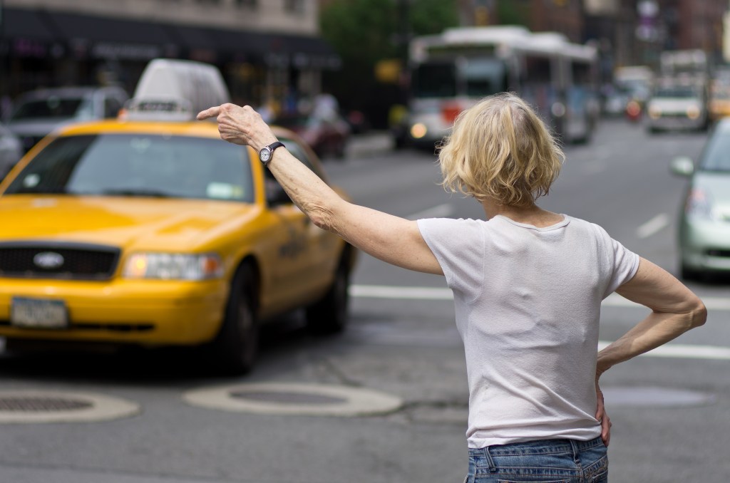 Person hailing a cab in New York City.
