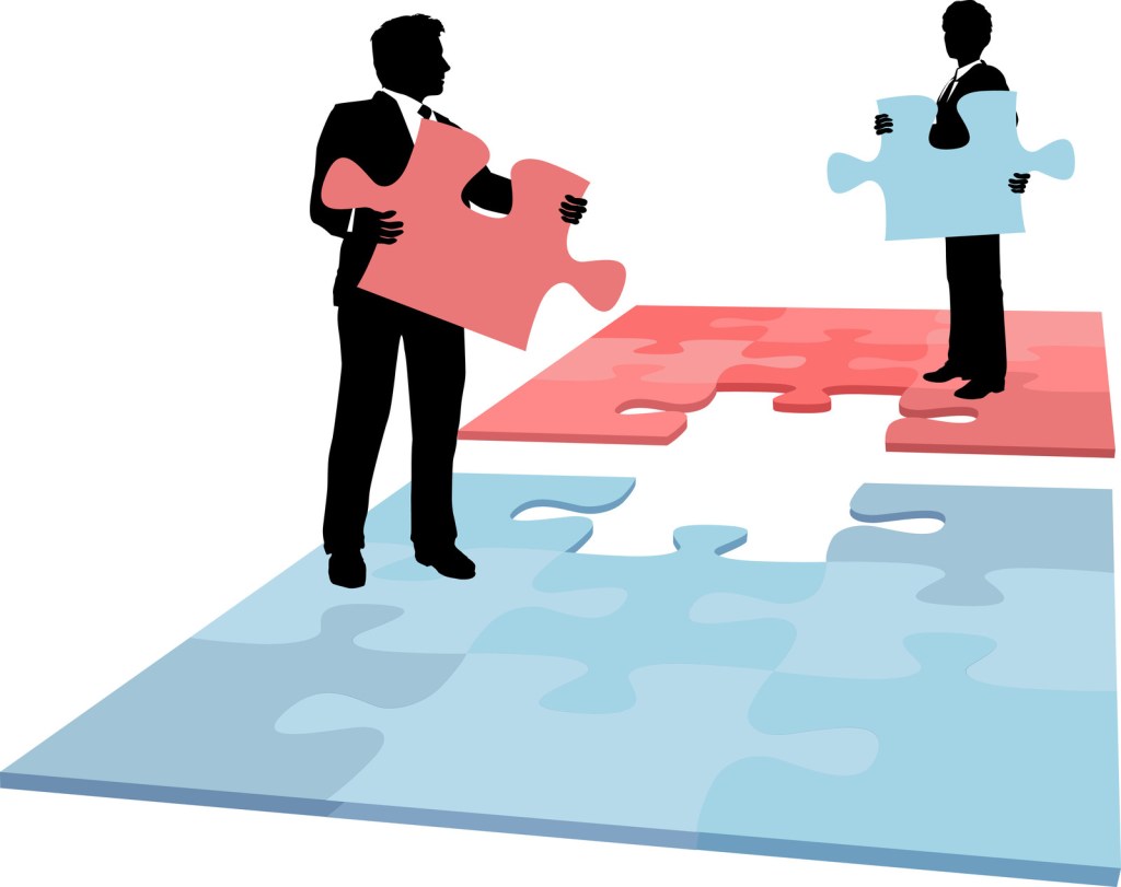 Two people with pieces filling in the missing slots on a puzzle.