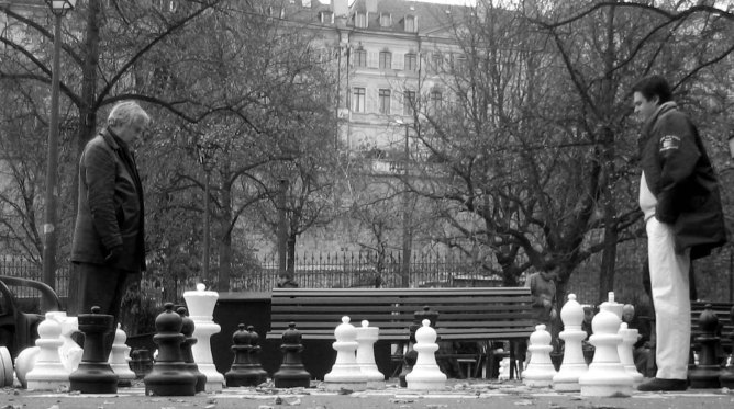 Chess match in park.