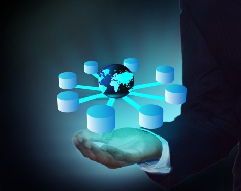 Hand holding a bunch of databases with the earth at center.