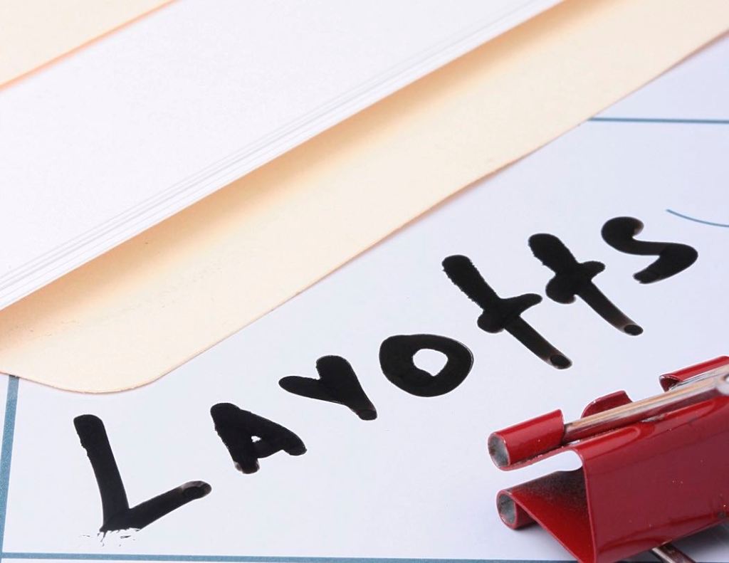 Folder with 'layoffs" written in black marker.