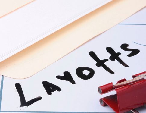 Folder with 'layoffs" written in black marker.