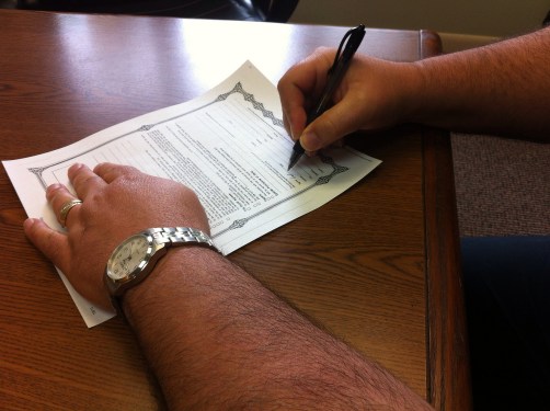 Man signing a contract.
