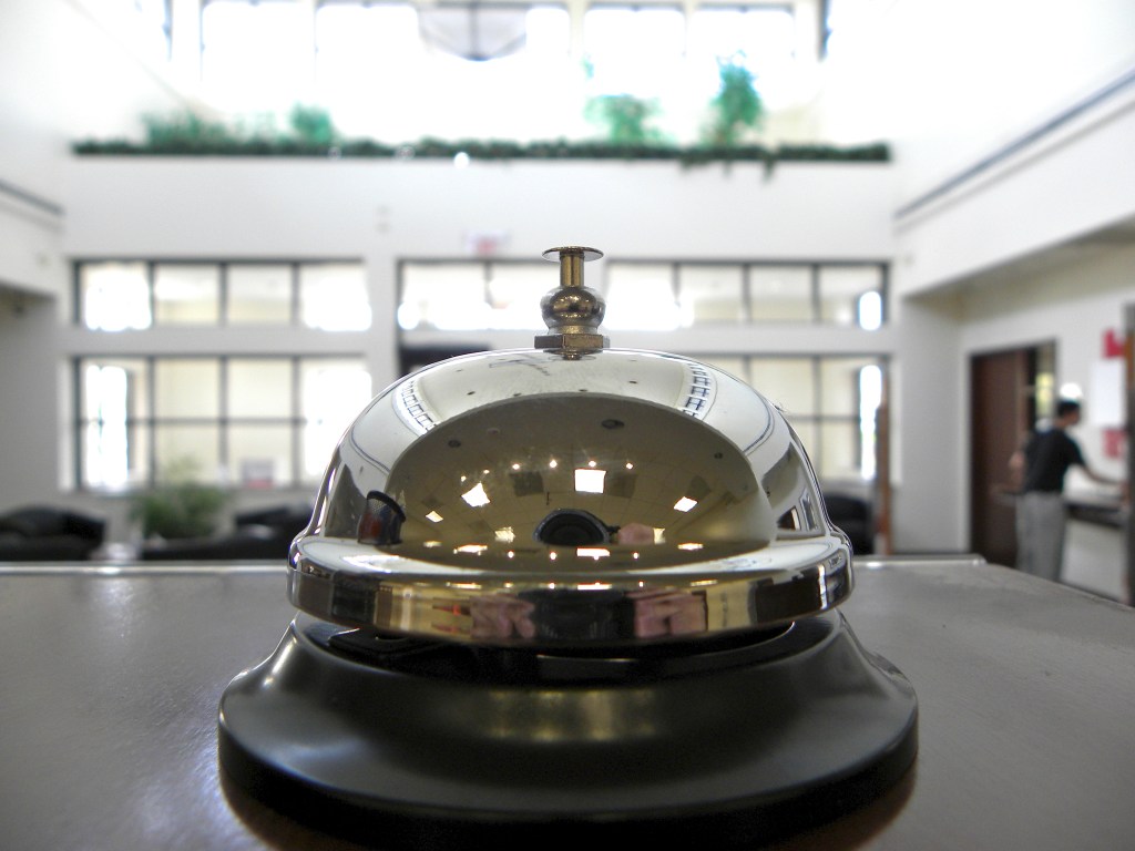 Kind of bell you ring for service sitting on a desk.