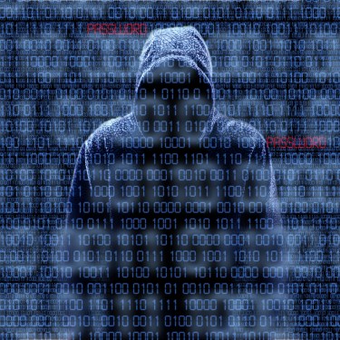 Hooded figure over zeros and ones background.