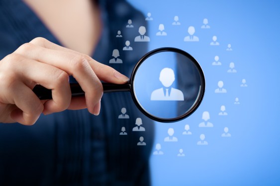 Woman pointing a concept picture of a network of people. One person has been selected in the center and stands out.
