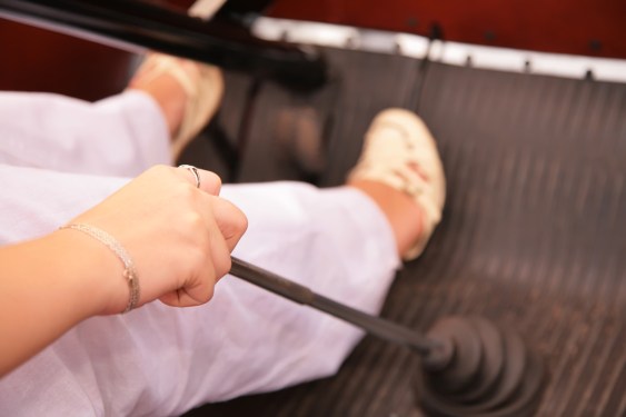 View of woman's legs pressing gas while shifting in a car.