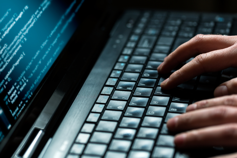 Hacker working at keyboard.