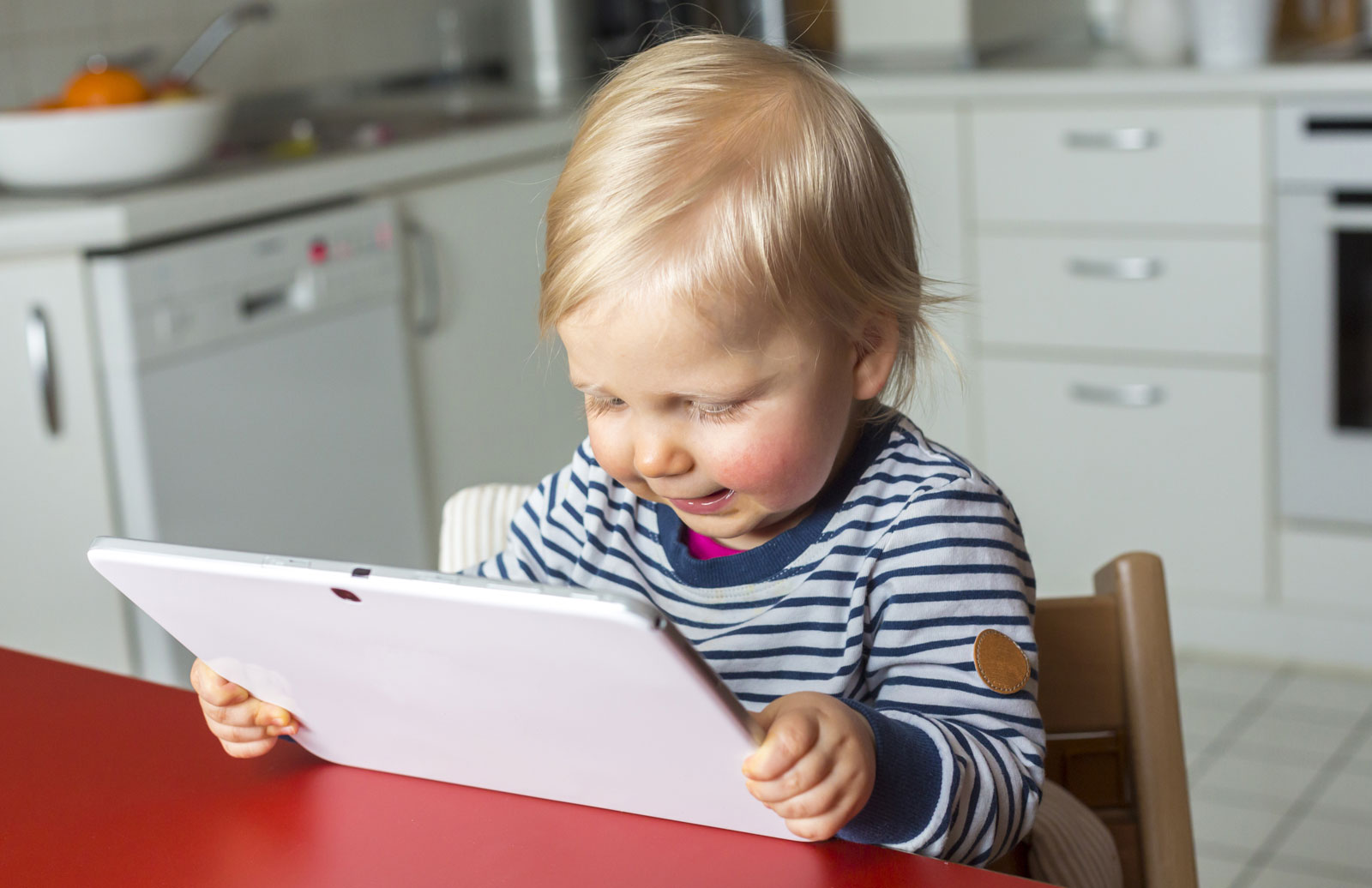 toddler plays with tablet