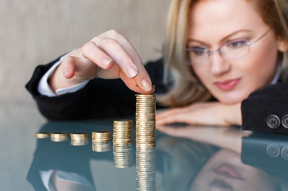Woman counting piles of coins