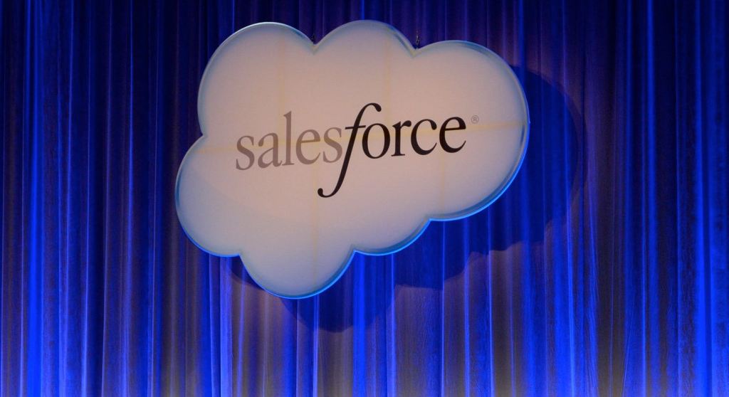 Salesforce cloud logo against blue curtain.