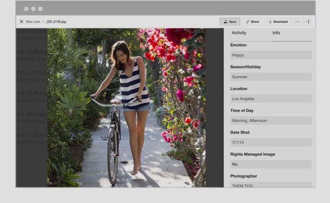 Picture of woman pushing bike through garden with metadata information next to it.