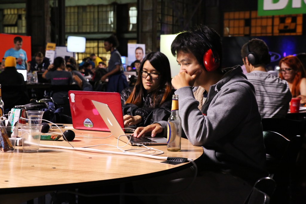 TechCrunch Disrupt Hackathon coders working on a program