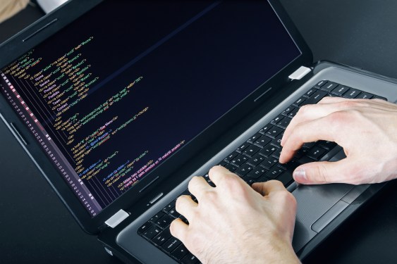 Hacker typing on laptop.
