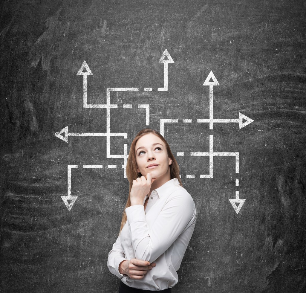 Woman pondering ideas that could take her in multiple directions.