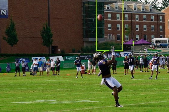 Football receiver hauling in a pass.