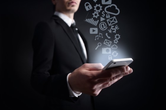 Business holding smart phone with apps flying out of it.