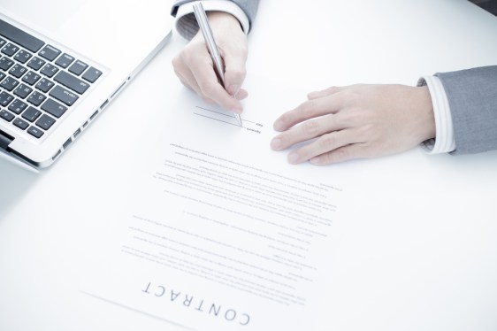 Business man signing a contract.