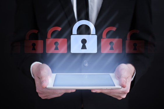 Business man holding tablets with locks over it to show internet security.