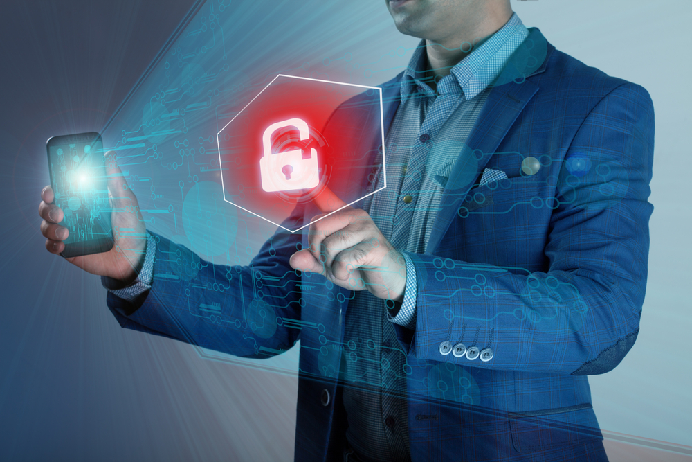 Business man holding smart phone while pressing a lock button to unlock it.