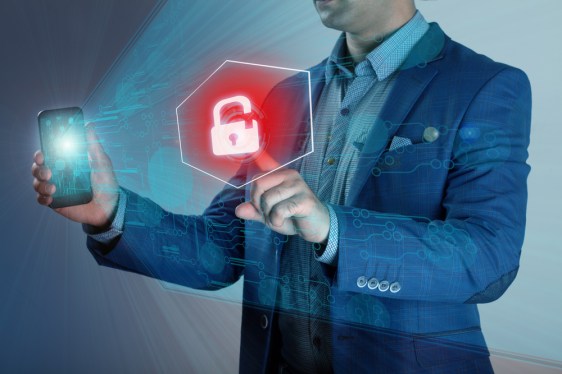 Business man holding smart phone while pressing a lock button to unlock it.