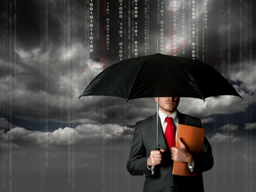 Business man carrying an umbrella to protect him from digital rain.