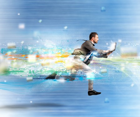 Business running with computer to illustrate speed.
