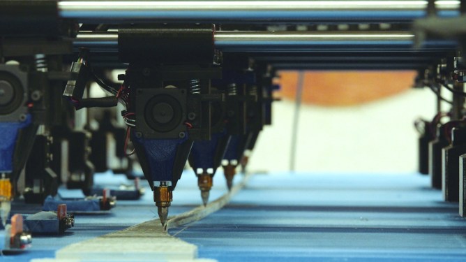 3D printing a part with multiple nozzles.