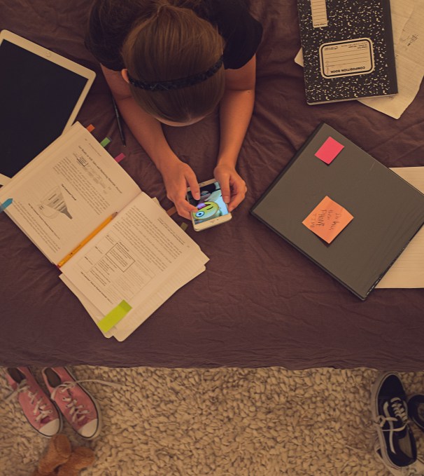 girl-doing-homework-on-bed