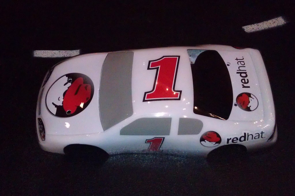 Red Hat race car with #1 painted on top.