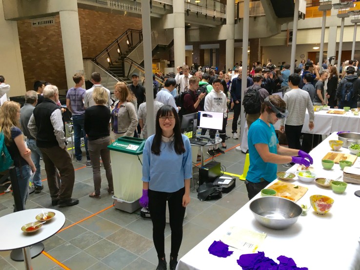 Students and guests mingle at the capstone project presentation day.