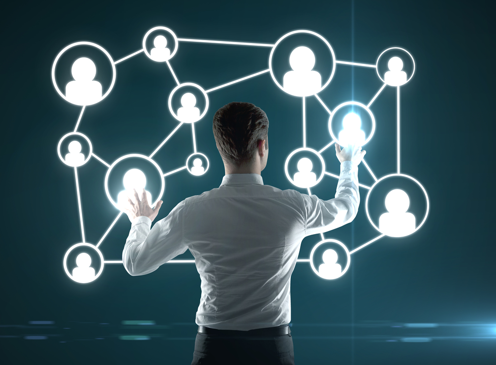 Business manipulating representation of social network.
