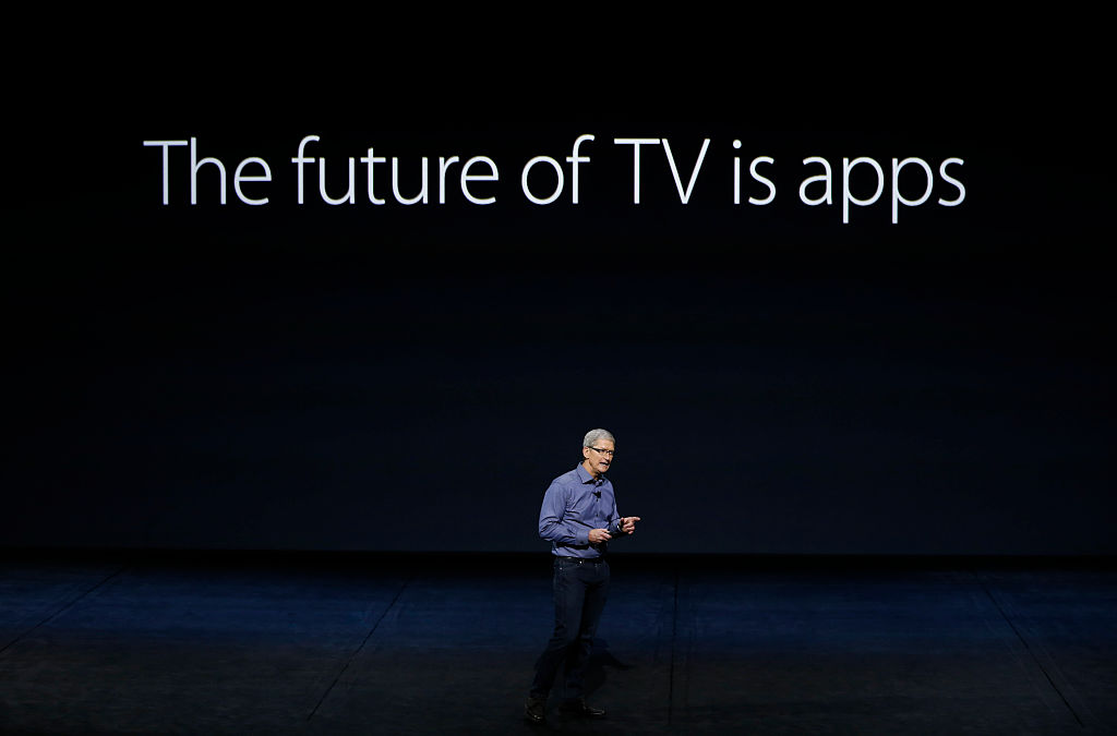 Tim Cook at Apple event standing in front of big sign: "The Future of TV is apps."