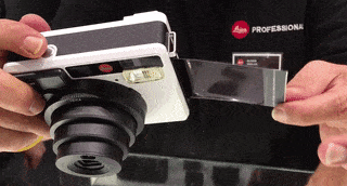 Through some spectacularly sophisticated video editing, it looks like the chap at the Leica stand re-inserts the film into the camera. Don't worry, he didn't. That would be silly. 