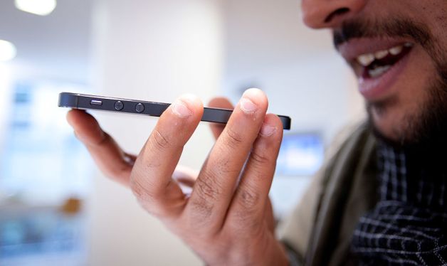 Man using voice commands on his iPhone.