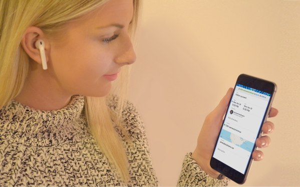 Woman with AirPods using Synqq app.
