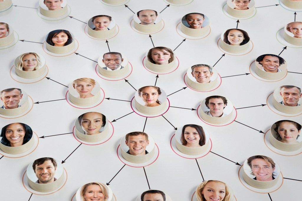 Faces on discs depicting a man as leader of a marketing or social scheme in the centre