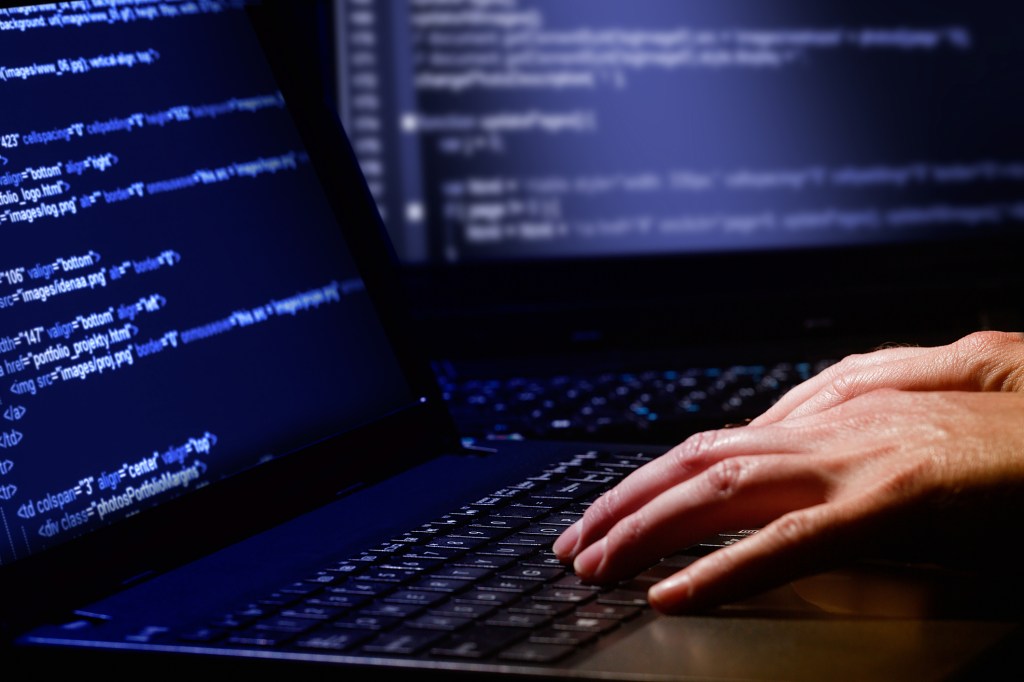 Hacker working on code